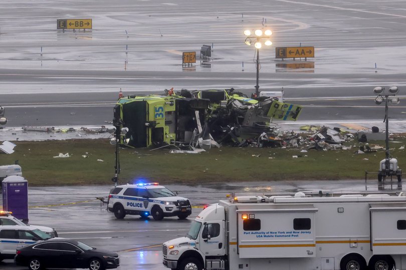 Debris around a damaged fire truck on the tarmac after an Air Canada Express plane collided with a fire truck at LaGuardia Airport.