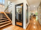 The Yamba home features a glass encased wine cellar and feature granite stone wall.