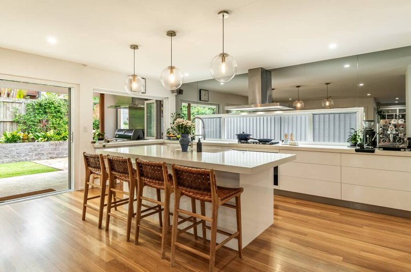 A state-of-the-art kitchen features a French imported handmade basin and dual Miele ovens.
