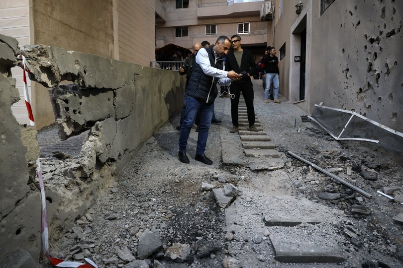 epa12846788 A man takes a picture at the site where fragments from an intercepted missile fell in Haret Sakher area, Kesrouan, north of Beirut, Lebanon, 24 March 2026. Lebanese authorities reported that fragments from an intercepted Iranian missile fell in the Haret Sakher area, in the Keserwan district, causing damage to a building. EPA/WAEL HAMZEH