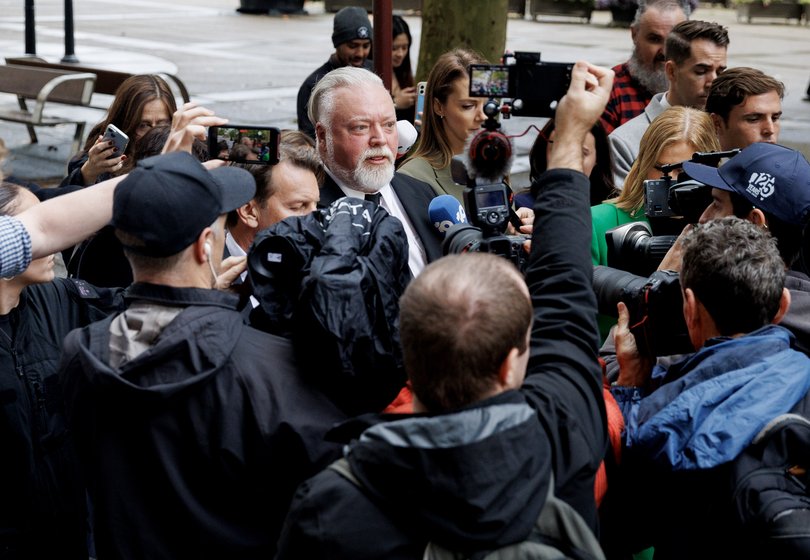 Kyle Sandilands surrounded by media as he leaves court. 