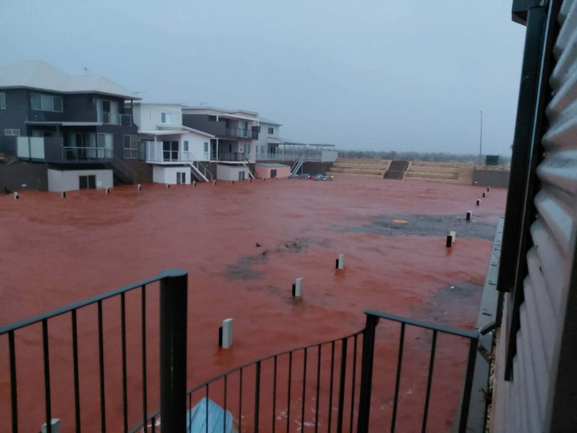 Flooding smashes through a residential site.