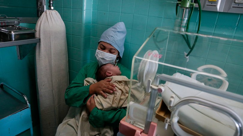 Liagny Acosta holds her 2-week-old baby, Aran, who is hospitalized for a respiratory illness at the Hospital William Soler in Havana on March 22, 2026. Amid a U.S. oil blockade causing daily blackouts across Cuba, doctors say that rapidly deteriorating conditions at hospitals and clinics are causing deaths that would otherwise be preventable. (Jorge Luis Baos/The New York Times)