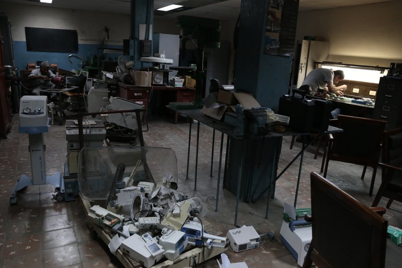 Using parts from old machines, technicians try to repair medical equipment at a Technical Electromedicine Services workshop in Havana on March 20, 2026.