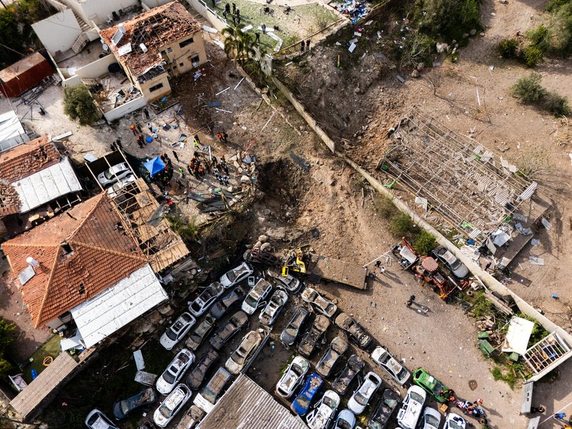 In this aerial view first responders gather near a crater left by an Iranian missile on March 28, 2026 in Beit Shemesh, Israel.