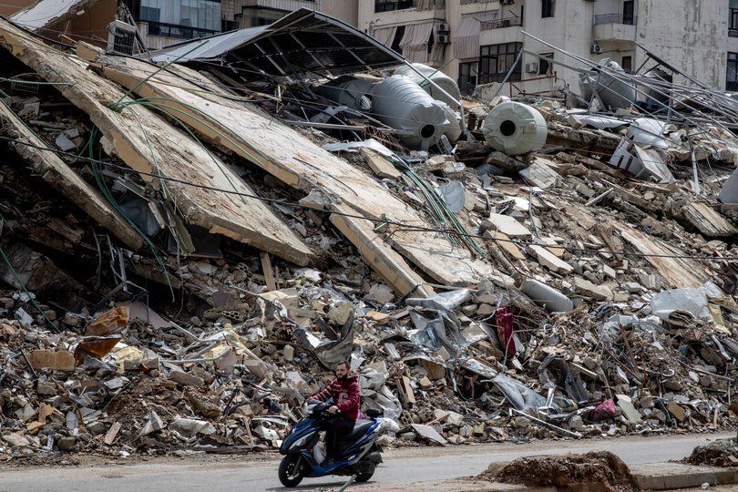 A motorbike passes by a building destroyed by an Israeli strike in the Dahyeh neighbourhood on March 28, 2026 in Beirut, Lebanon.