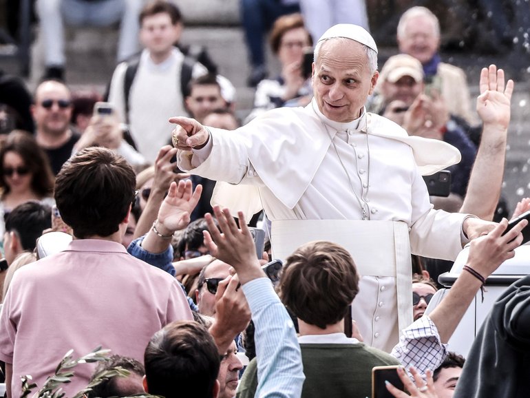Pope Leo XIV greets the faithful at the end of the Palm Sunday Mass in St. Peter's Square. 