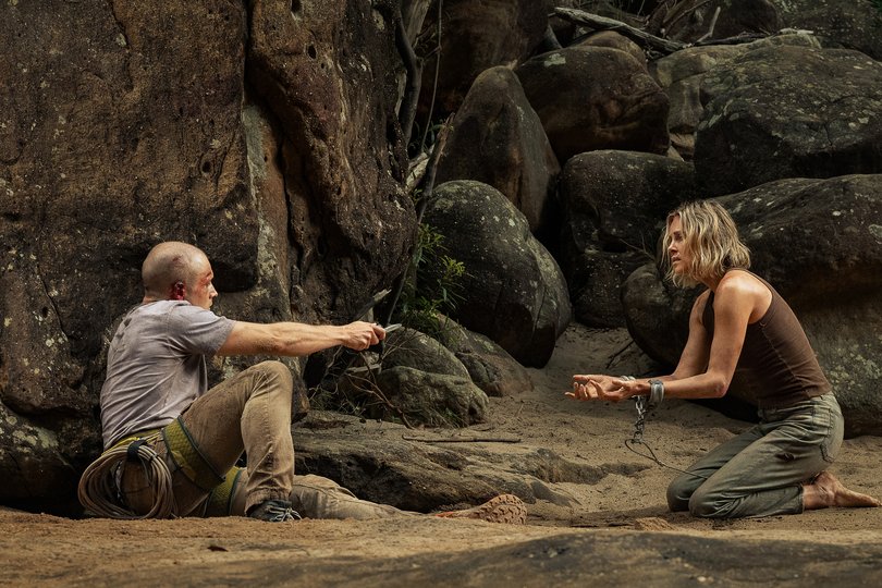 Taron Egerton and Charlize Theron in Apex.