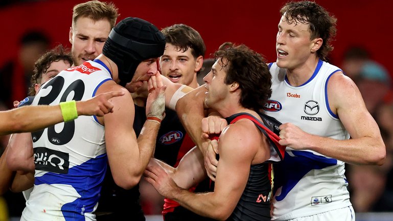 Tristan Xerri of the Kangaroos wipes blood on the face of Andrew McGrath.