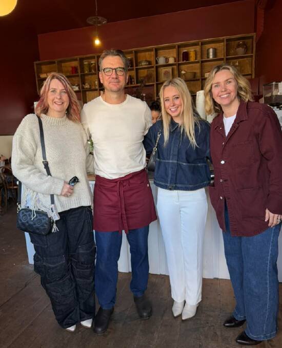 The couple with customers at The Village Grocer. Picture Facebook