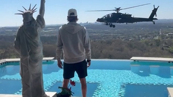 Kid Rock watches the helicopter outside his home.