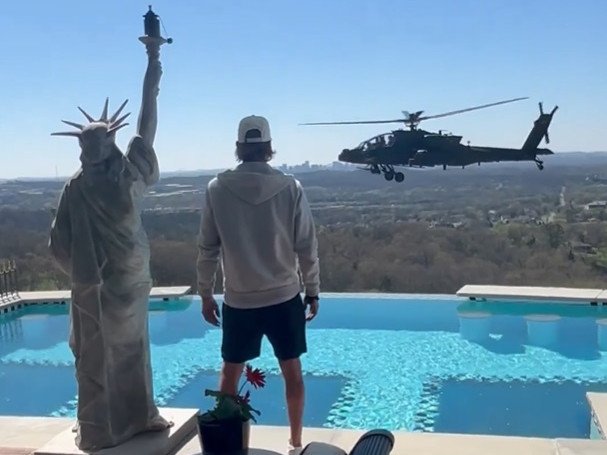 Kid Rock watches the helicopter outside his home.