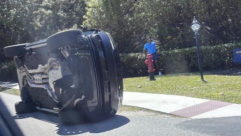 Tiger Woods stands by his overturned vehicle in Jupiter Island after last Friday's crash.