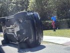 Tiger Woods stands by his overturned vehicle in Jupiter Island after last Friday's crash.