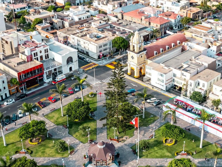 Flying with drone above La Punta del Callao in Lima, a small peninsula deep in the Pacific ocean with residential homes and beaches. 