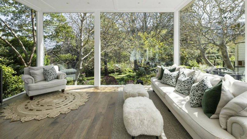 A conservatory offers sweeping views of the surrounding gardens.