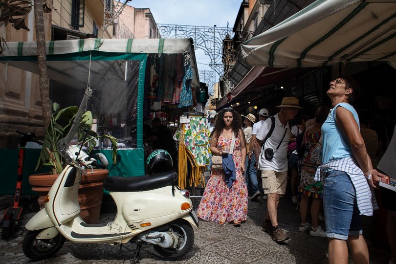 Tourists meander through Mercato del Capo.