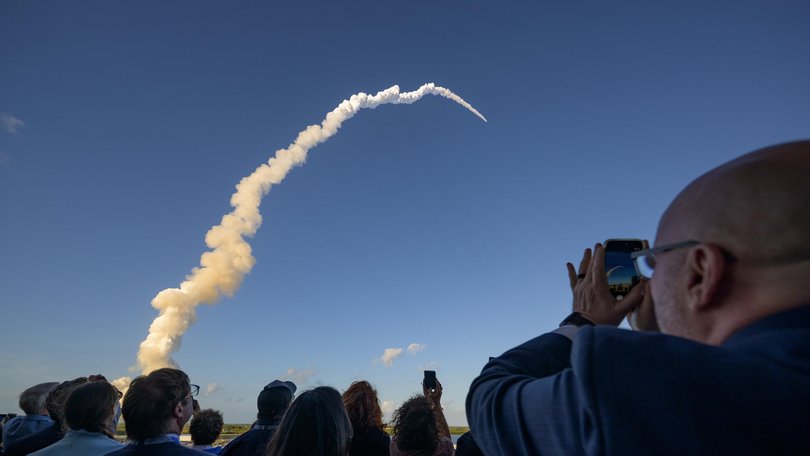 Spectators watch the launch at Kennedy Space Centre.