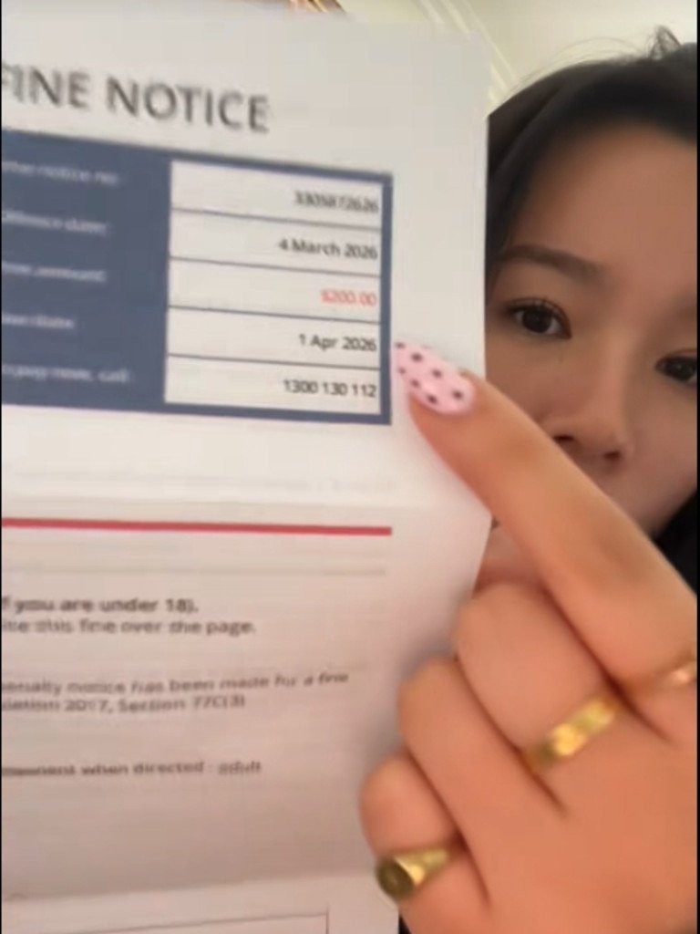 The Sydney student showed on camera what appears to be a fine, which she claims was issued to her by Transport NSW officers for a ‘crazy’ reason. Picture: TikTok