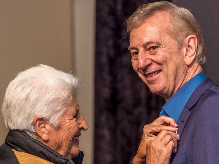 In 2019, Dawn Fraser presented Dennis Cometti with a pin, as the man who defined a generation of sport honoured with a State Memorial. Jake Nowakowski