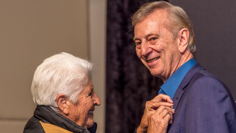 In 2019, Dawn Fraser presented Dennis Cometti with a pin, as the man who defined a generation of sport honoured with a State Memorial. Picture: Jake Nowakowski