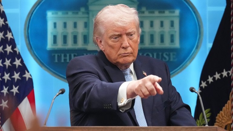 President Donald Trump speaks with reporters during a news conference at the White House.