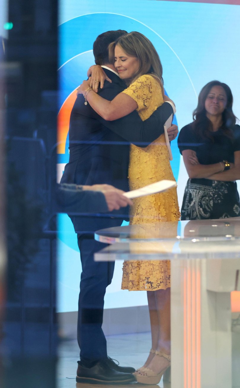 Savannah Guthrie embraces Carson Daly on set.