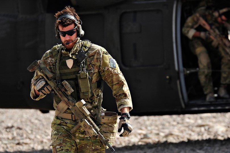 SAS Corporal Ben Roberts-Smith VC, MG, with the Australian Special Operations Task Group, leaves a UH-60 Blackhawk helicopter during preparation of the Shah Wali Kot offensive in Afghanistan, 2010. 
