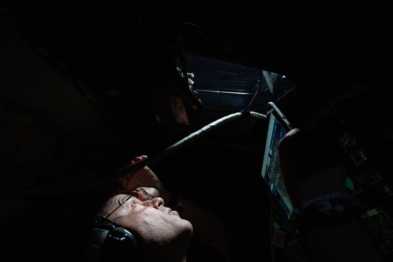 Reid Wiseman, commander of the Artemis II mission, peering through a window of the Orion Integrity spacecraft during the flyby around the far side of the Moon.
