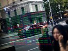 Pedestrians are reflected in a window as they walk past an electronic stock board at the ASX Ltd. exchange centre in Sydney, Australia, on Thursday, Feb. 14, 2019. “We made good progress on our core initiatives across the period, including the program to replace CHESS with distributed ledger technology; upgrade of our secondary data centre to strengthen market resilience; and restructure of our Listings Compliance team to enhance the quality of market oversight,” ASX Chief Executive Officer Dominic Stevens said. Photographer: David Moir/Bloombergrket resilience; and restructure of our Listings Compliance team to enhance the quality of market oversight,” ASX Chief Executive Officer Dominic Stevens said. Photographer: David Moir/Bloomberg David Moir