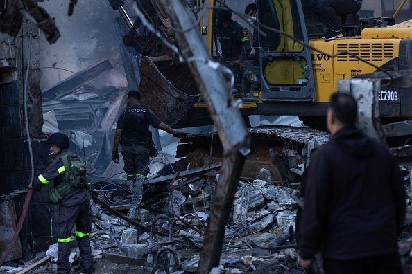 Rescue workers search for people after an Israeli attack hit a residential building in the Corniche al Mazraa neighbourhood on April 8.