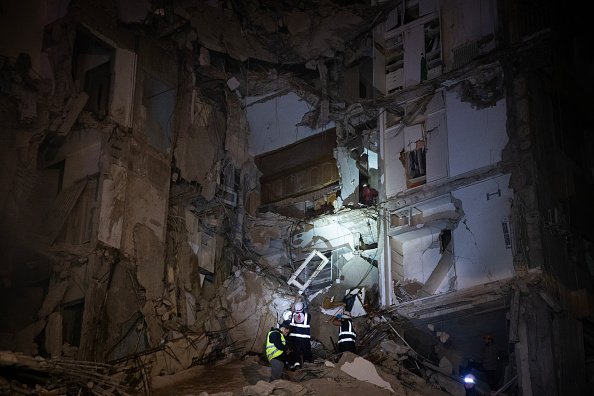 Rescue workers search the rubble for survivors and casualties after an Israeli attack targeted a residential building.