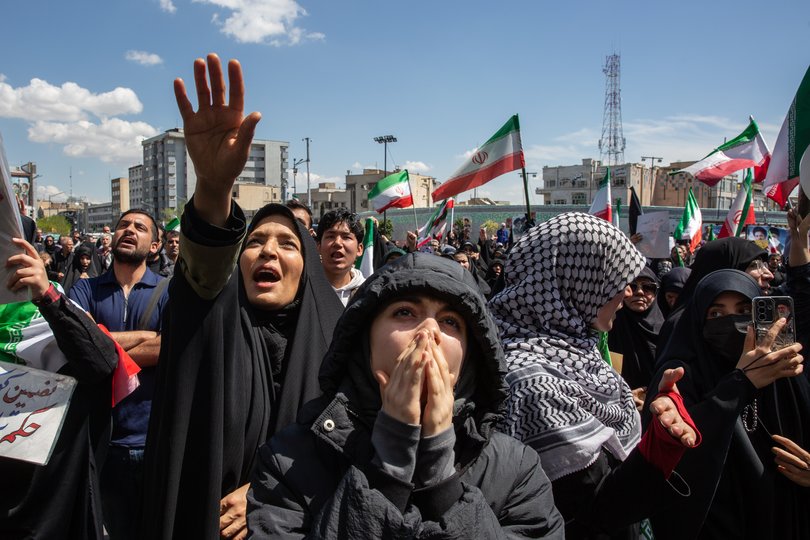 Pro-government demonstrators gather after an announcement of a two-week ceasefire in Tehran.