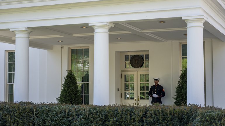 A Marine sentry stationed outside the West Wing, signifying the President was inside, at the White House on April 7.