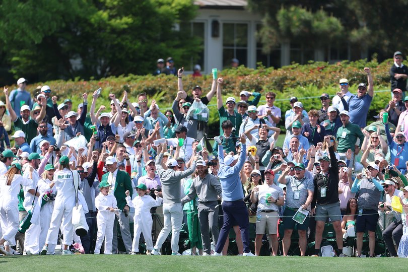 Tommy Fleetwood of England celebrates a hole-in-one with Rory McIlroy.