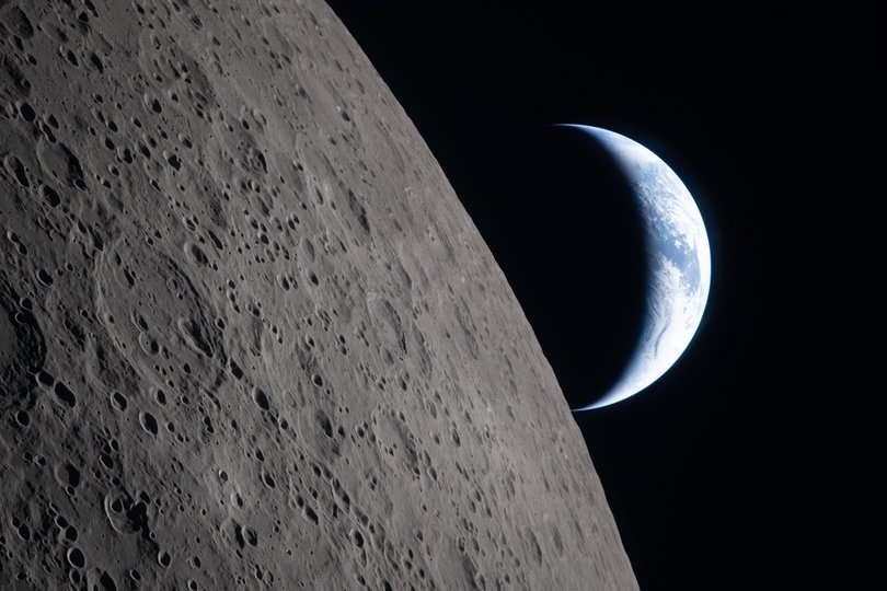 The crew captured this image of a crescent Earth setting on the “lunar limb”.