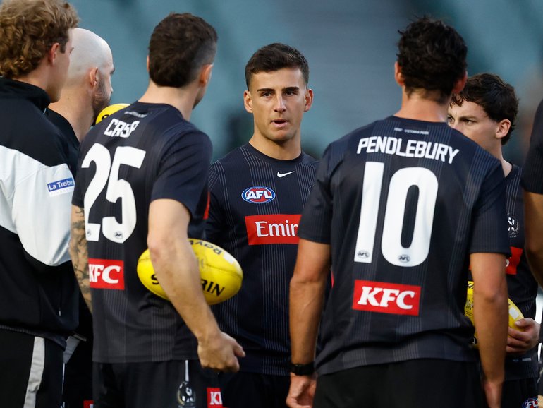 Nick Daicos speaks with teammates.
