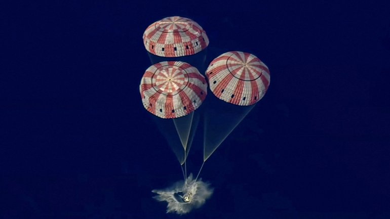 A photo provided by NASA shows the Artemis II crew capsule as it splashes down in the Pacific Ocean after the Artemis II crew's flyby of the Moon, on Thursday, April 10, 2026. The NASA flight parachuted into the Pacific Ocean near San Diego, bringing to an end a journey that sent humans into deep space for the first time since 1972.  (NASA via The New York Times) —NO SALES; FOR EDITORIAL USE ONLY —