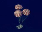 A photo provided by NASA shows the Artemis II crew capsule as it splashes down in the Pacific Ocean after the Artemis II crew's flyby of the Moon, on Thursday, April 10, 2026. The NASA flight parachuted into the Pacific Ocean near San Diego, bringing to an end a journey that sent humans into deep space for the first time since 1972.  (NASA via The New York Times) —NO SALES; FOR EDITORIAL USE ONLY —