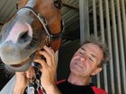 Queensland jockey Shane McGovern is in an induced coma in Townsville Hospital after he was trapped underneath a dead horse.