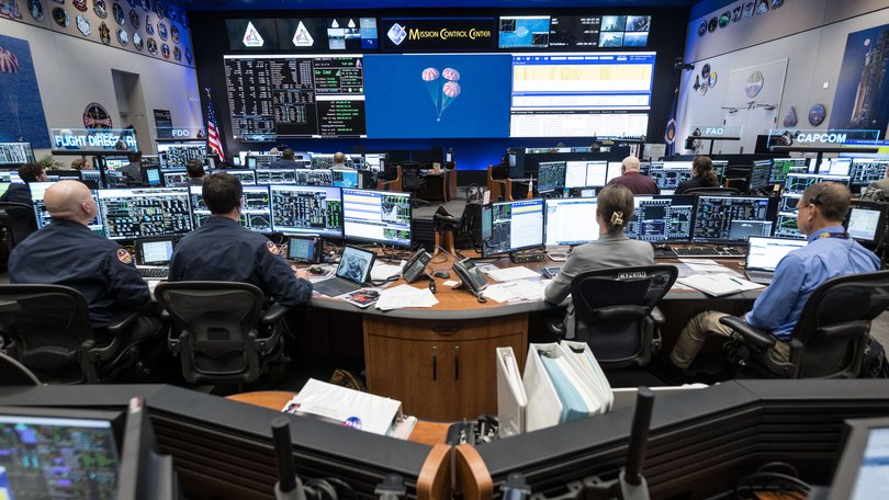 Artemis II Flight Control Team pictured at consoles within the White Flight Control Room in the Mission Control Center at NASA’s Johnson Space Center for the splashdown and recovery of the Artemis II crew as it landed in the Pacific Ocean off the coast of California.