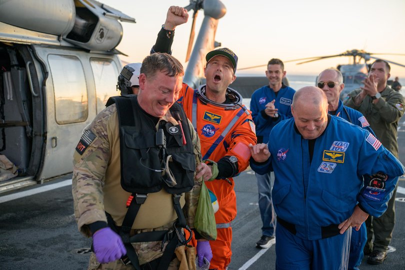 NASA astronaut Reid Wiseman, Artemis II commander is assisted off the flight deck after arriving aboard USS John P. Murtha after he and fellow crewmates were extracted from their Orion spacecraft after splashdown, Friday, April 10, 2026, in the Pacific Ocean off the coast of California. 