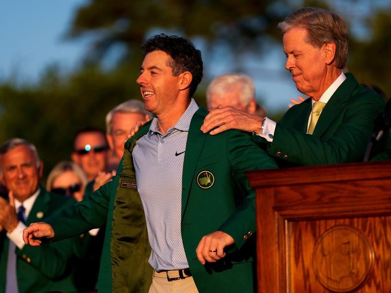 Rory McIlroy receives his second Masters green jacket from Masters chairman Fred Ridley. (AP PHOTO)