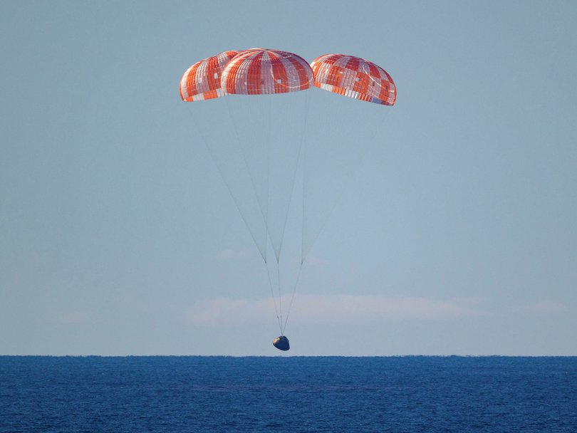 The parachutes deployed over the Pacific Ocean.