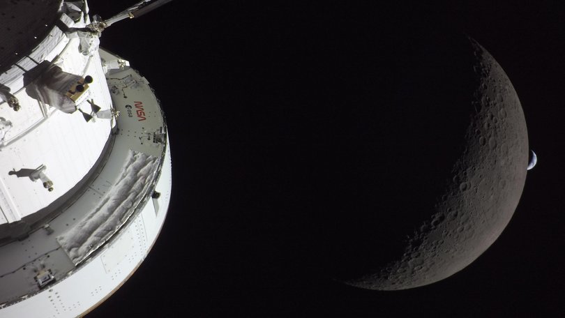 The Orion spacecraft takes a selfie with the moon and the Earth.