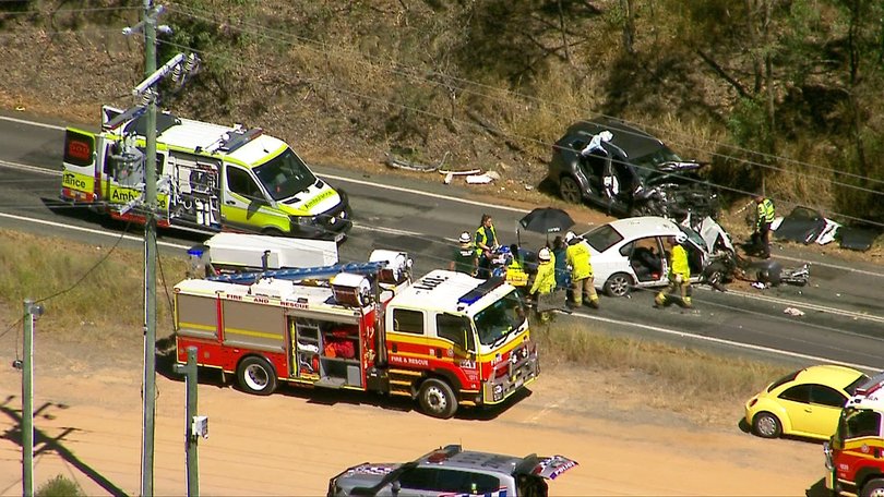 Aerial view of the crash scene showing multiple emergency crews responding on Tamborine Mountain Rd.