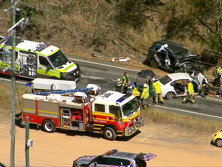 Aerial view of the crash scene showing multiple emergency crews responding on Tamborine Mountain Rd.