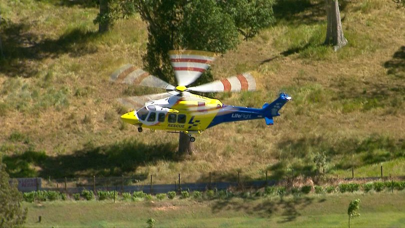 A rescue helicopter departs the scene after transporting injured patients to hospital.