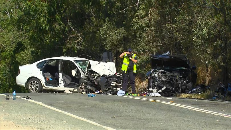 Two vehicles with severe front-end damage and the crushed motorbike after the multi-vehicle crash.