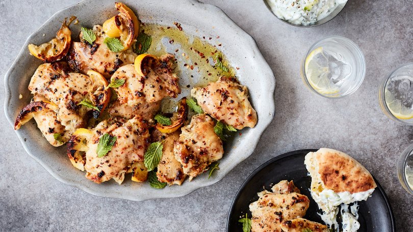 Roasted chicken thighs with garlicky cucumber yoghurt in New York on Sept. 10, 2021. Delicate boneless, skinless thighs cook quickly, aren't prone to drying out and pair beautifully with a garlicky cucumber yoghurt. Food Stylist: Simon Andrews. Prop Stylist: Christina Lane.(Johnny Miller/The New York Times)